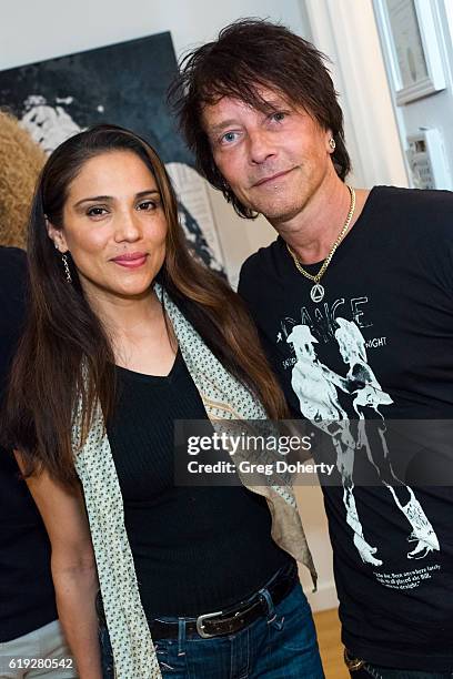 Actress Tonantzin Carmelo and Artist Billy Morrison pose for a picture at the Gallery Opening Of "Social Distortion: A Capsule Collection Of Fine Art...