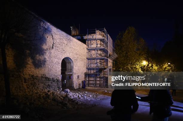 Picture shows a damaged wall outside the historic center of Norcia on October 30, 2016 after a 6.6 magnitude earthquake hit central Italy early in...