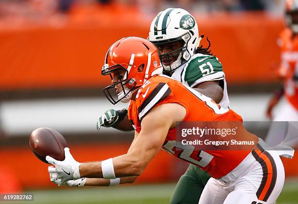 Gary Barnidge of the Cleveland Browns makes a catch in front of Julian Stanford of the New York Jets during the first quarter at FirstEnergy Stadium...