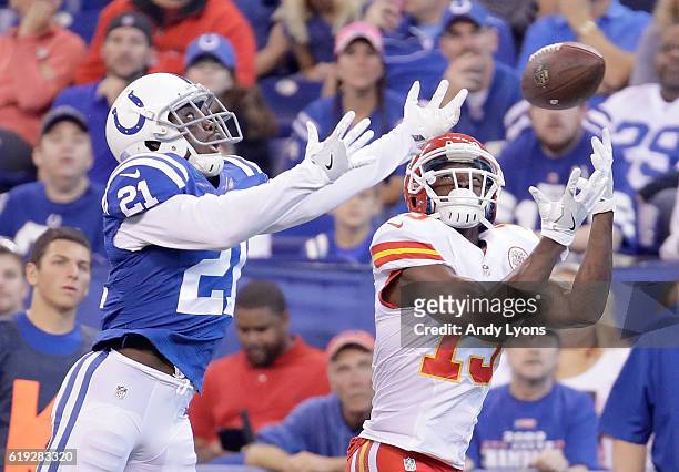 De'Anthony Thomas of the Kansas City Chiefs attempts to catch a pass while being guarded by Vontae Davis of the Indianapolis Colts during the first...