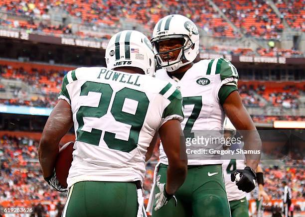 Bilal Powell of the New York Jets celebrates his second quarter touchdown with Charone Peake against the Cleveland Browns at FirstEnergy Stadium on...