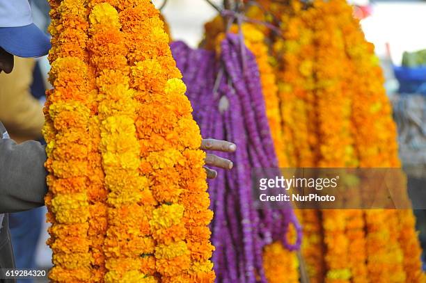 Nepalese street vendor selling marigold flower for the offering towards Goddess Laxmi during Laxmi Puja as the procession of Tihar or Deepawali and...