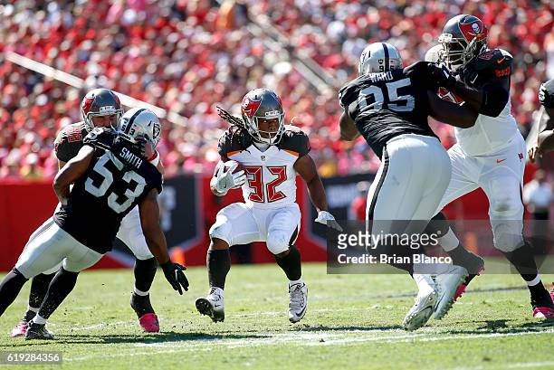 Running back Jacquizz Rodgers of the Tampa Bay Buccaneers gets some help from tight end Luke Stocker and tackle Demar Dotson as he finds room to run...