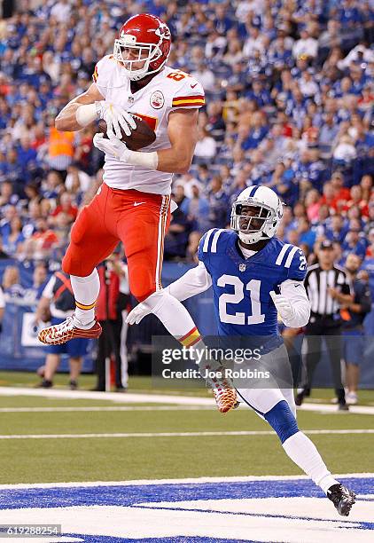 Travis Kelce of the Kansas City Chiefs catches a touchdown pass while being guarded by Vontae Davis of the Indianapolis Colts during the second...