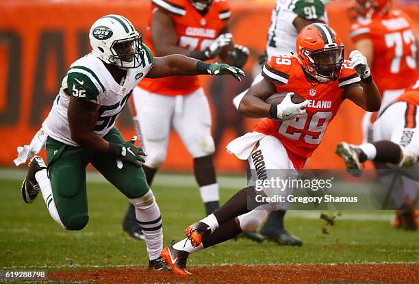 Duke Johnson of the Cleveland Browns carries the ball in front of David Harris of the New York Jets during the second quarter at FirstEnergy Stadium...