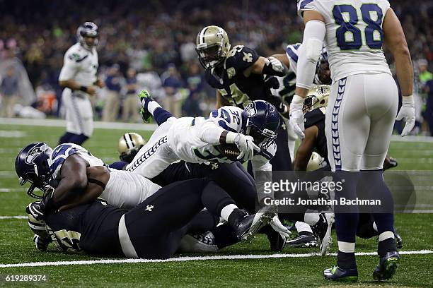 Christine Michael of the Seattle Seahawks scores a touchdown during the first half of a game against the New Orleans Saints at the Mercedes-Benz...