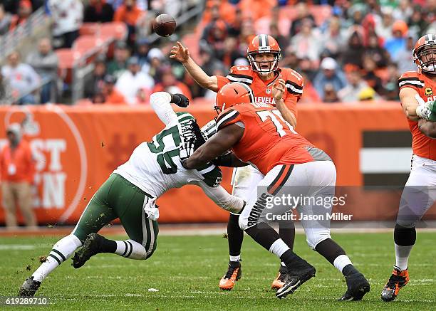 Josh McCown of the Cleveland Browns throws a pass in front of the defense of Lorenzo Mauldin of the New York Jets during the second quarter at...