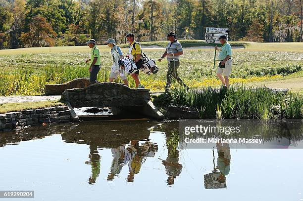 The group of Michael Putnam and Mark Wilson walk from the third tee during the Final Round of the Sanderson Farms Championship at the Country Club of...