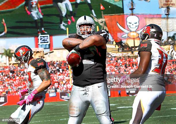 Tackle Donald Penn of the Oakland Raiders stares into the stands after catching a touchdown pass in the third quarter against the Tampa Bay...