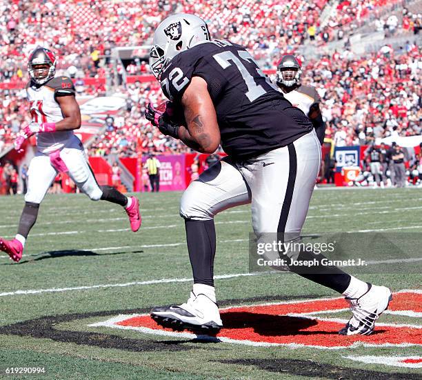 Tackle Donald Penn of the Oakland Raiders catches a touchdown pass in the third quarter against the Tampa Bay Buccaneers to tie the game at 10-10 at...