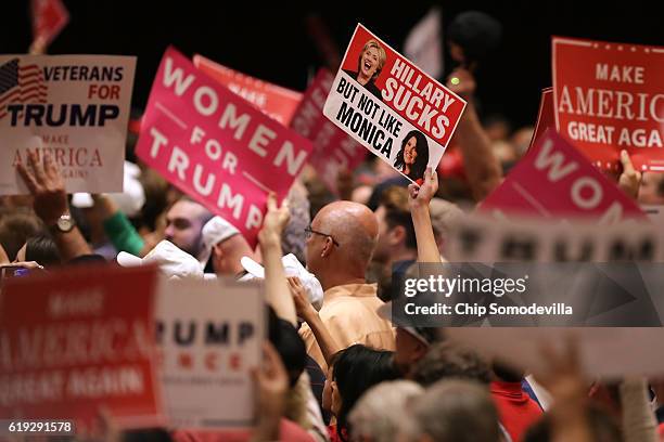 Supporters hold up signs during a campaign rally with Republican presidential nominee Donald Trump at The Venetian Las Vegas October 30, 2016 in Las...