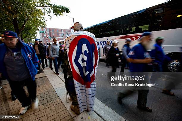 Man covers himself in a Cubs banner, prior to Game Three of the 2016 World Series between the Chicago Cubs and the Cleveland Indians at Wrigley Field...