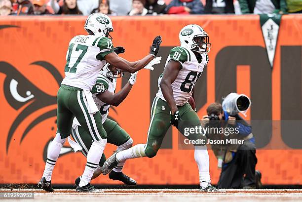 Quincy Enunwa of the New York Jets celebrates his touchdown with Bilal Powell and Charone Peake during the third quarter against the Cleveland Browns...