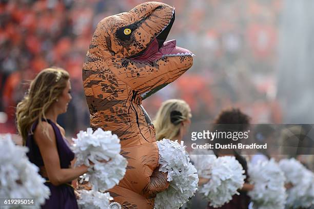 Denver Broncos cheerleader in a dinosaur costume before the game against the San Diego Chargers at Sports Authority Field at Mile High on October 30,...