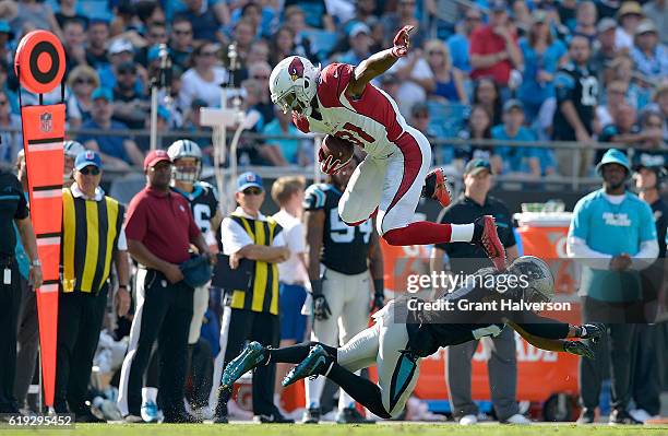 David Johnson of the Arizona Cardinals leaps over Robert McClain of the Carolina Panthers in the 3rd quarter during the game at Bank of America...