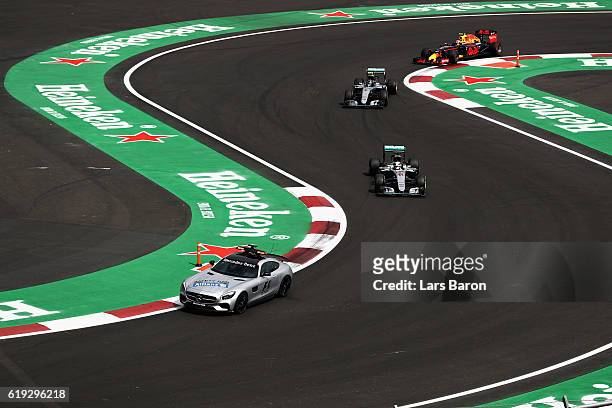 The safety car leads Lewis Hamilton of Great Britain driving the Mercedes AMG Petronas F1 Team Mercedes F1 WO7 Mercedes PU106C Hybrid turbo, Nico...