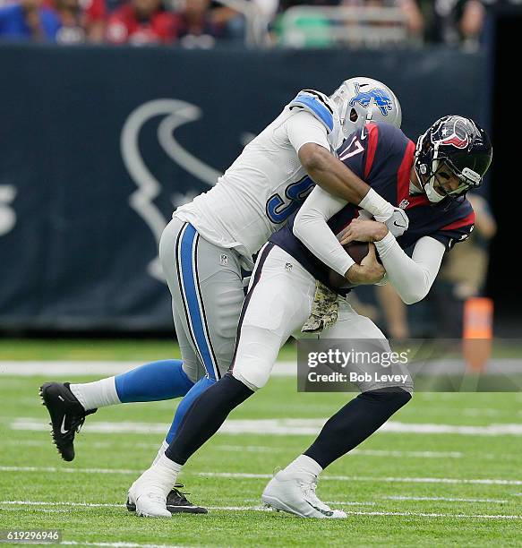 Brock Osweiler of the Houston Texans is sacked by Armonty Bryant of the Detroit Lions at NRG Stadium on October 30, 2016 in Houston, Texas.