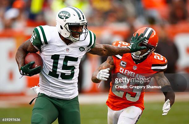 Brandon Marshall of the New York Jets stiff arms Joe Haden of the Cleveland Browns during the fourth quarter at FirstEnergy Stadium on October 30,...