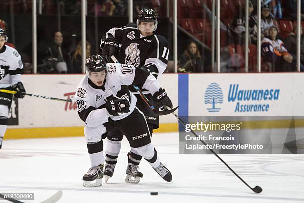 Vitalii Abramov of the Gatineau Olympiques battles for the puck against Axel Simic of the Blainville-Boisbriand Armada on October 30, 2016 at Robert...