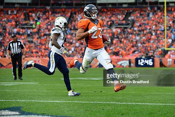 Running back Devontae Booker of the Denver Broncos rushes for a touchdown in the third quarter of the game against the San Diego Chargers at Sports...