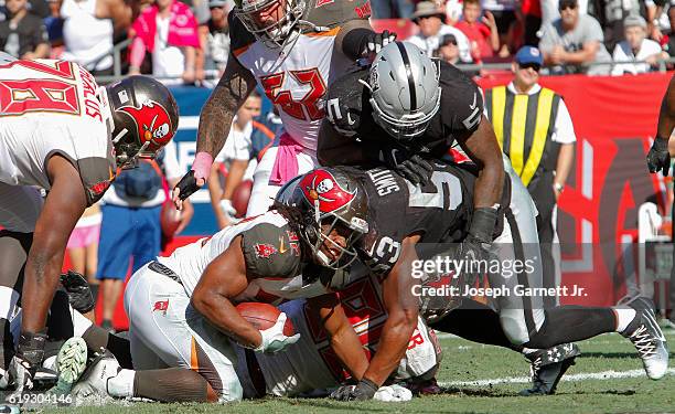 Running back Jacquizz Rodgers of the Tampa Bay Buccaneers scores a touchdown in the fourth quarter against the Oakland Raiders at Raymond James...