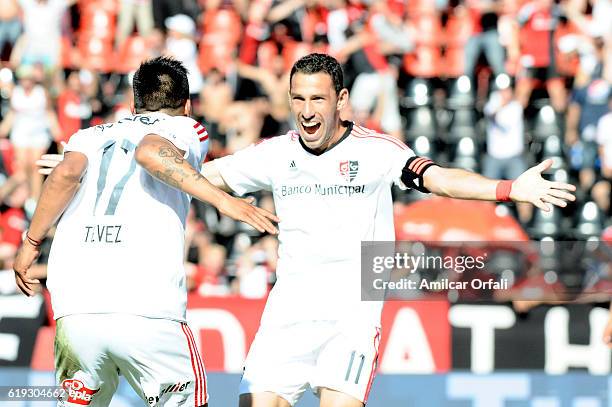 Maximiliano Rodriguez of Newell's Old Boys celebrates with teammate Mauricio Tevez after scoring the second goal of his team during a match between...