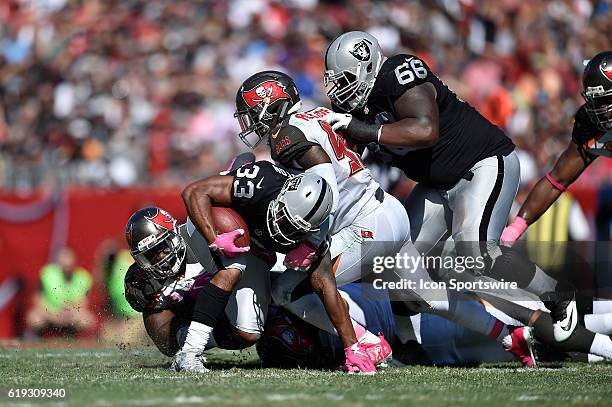 Oakland Raiders Running Back DeAndre Washington tries to avoid the tackle by Tampa Bay Buccaneers Defensive End Robert Ayers during an NFL football...