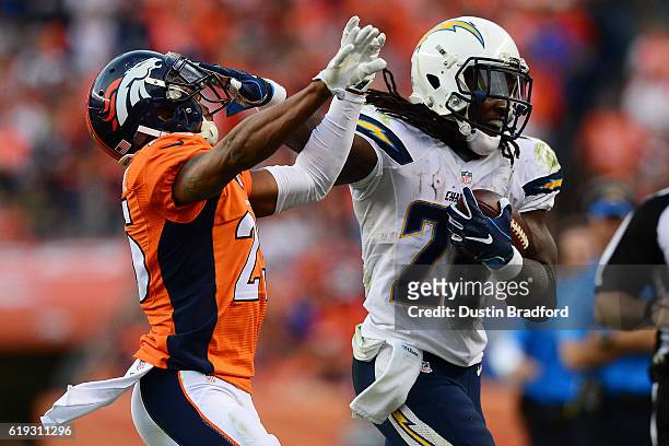 Running back Melvin Gordon of the San Diego Chargers fights off cornerback Chris Harris of the Denver Broncos in the fourth quarter of the game at...