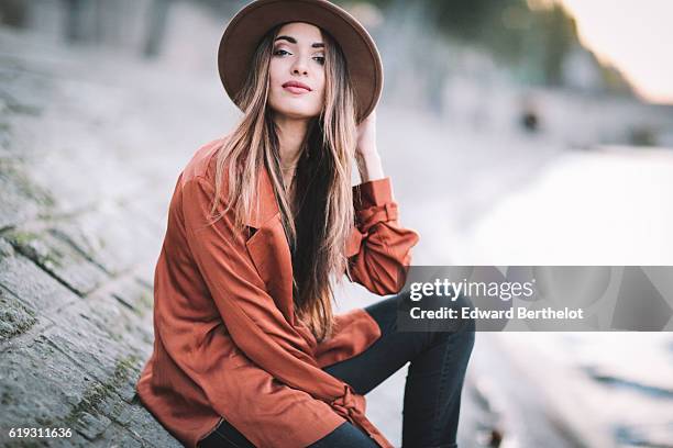 Sofya Benzakour , is wearing a hat, Reiko denim jeans, a Nakd Fashion orange shirt, Zara boots, and a Gucci brown bag, on October 30, 2016 in Paris,...