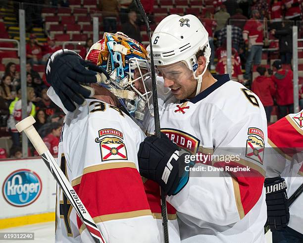 Alex Petrovic of the Florida Panthers congratulates teammate James Reimer for the victory after an NHL game against the Detroit Red Wings at Joe...