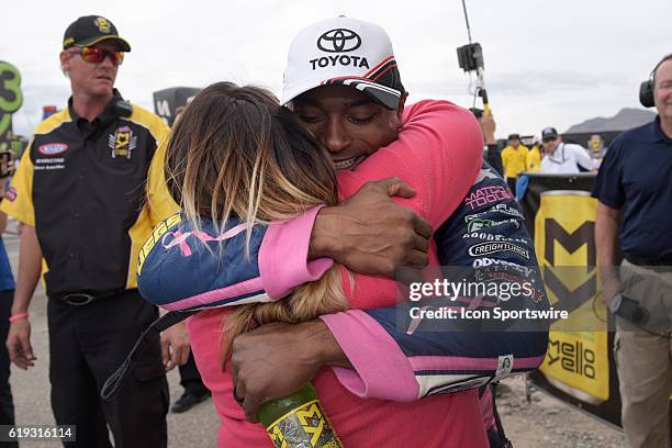 Antron Brown Don Schumacher Racing NHRA Top Fuel Dragster hugs his wife Billie Jo Brown after leaning he had clinched the NHRA Top Fuel championship...