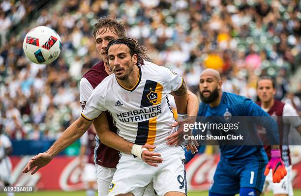 Alan Gordon of Los Angeles Galaxy is closely defended during Los Angeles Galaxy's MLS Playoff Semifinal match against Colorado Rapids at the StubHub...