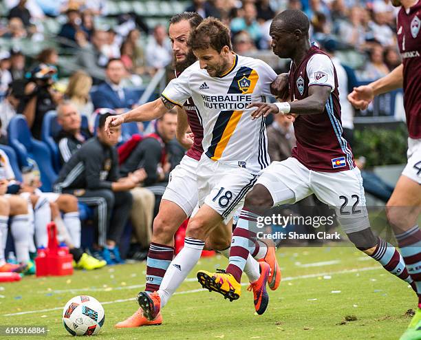 Mike Magee of Los Angeles Galaxy battles Michael Azira of Colorado Rapids during Los Angeles Galaxy's MLS Playoff Semifinal match against Colorado...