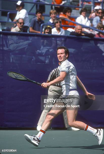 John McEnroe of the United States hits a return during a match in the Men's 1985 US Open Tennis Championships circa 1985 at the National Tennis...