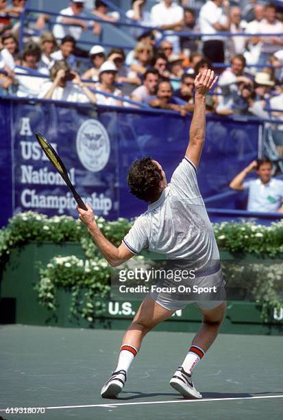 John McEnroe of the United States serves during a match in the Men's 1985 US Open Tennis Championships circa 1985 at the National Tennis Center in...