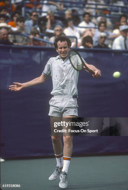 John McEnroe of the United States hits a return during a match in the Men's 1985 US Open Tennis Championships circa 1985 at the National Tennis...