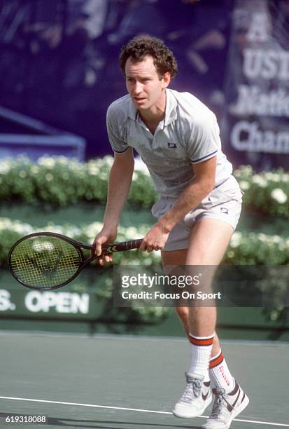 John McEnroe of the United States serves during a match in the Men's 1985 US Open Tennis Championships circa 1985 at the National Tennis Center in...