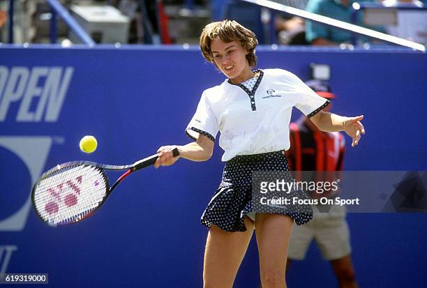 Tennis player Martina Hingis of Switzerland hits a return during the women 1996 U.S. Open Tennis Tournament circa 1996 at the USTA National Tennis...
