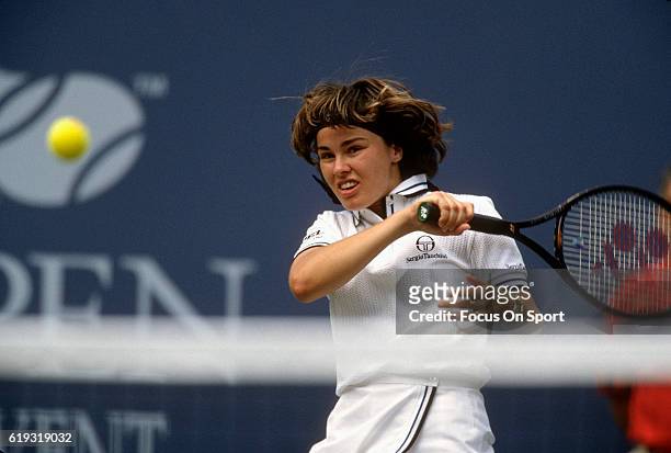 Tennis player Martina Hingis of Switzerland hits a return against Venus Williams during the women 1997 U.S. Open Tennis Tournament September 6, 1997...