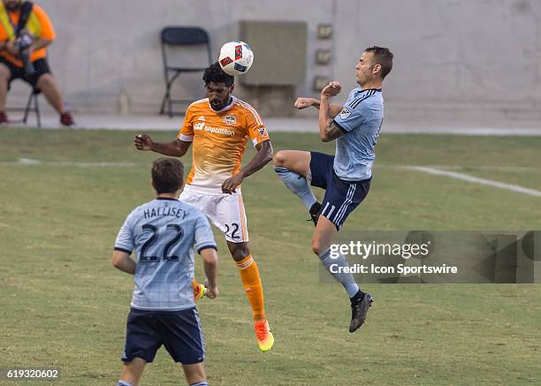 Houston Dynamo midfielder Sheanon Williams and Sporting Kansas City midfielder Brad Davis go up for a header during the Lamar Hunt US Open Cup soccer...