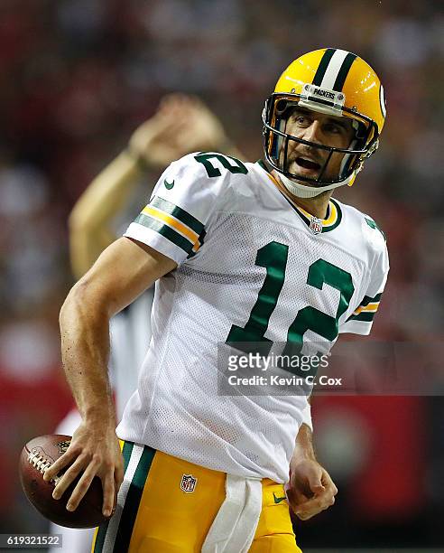 Aaron Rodgers of the Green Bay Packers reacts after rushing for a first down against the Atlanta Falcons at Georgia Dome on October 30, 2016 in...