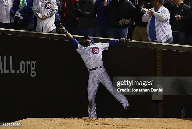 Jason Heyward of the Chicago Cubs catches a foul ball in the third inning against the Cleveland Indians in Game Five of the 2016 World Series at...