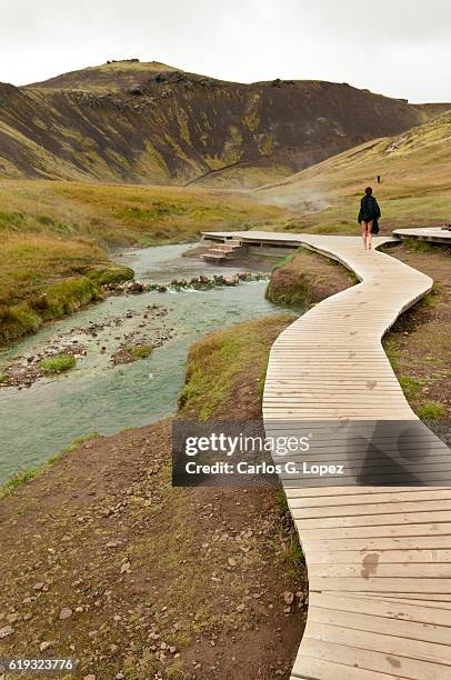 girl walking on deck near hotsprings - reiseroute golden circle stock-fotos und bilder