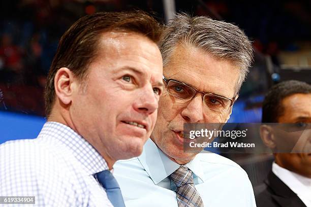 Assistant coaches Martin Gelinas and Dave Cameron of the Calgary Flames have a discussion during an NHL game against the Washington Capitals on...