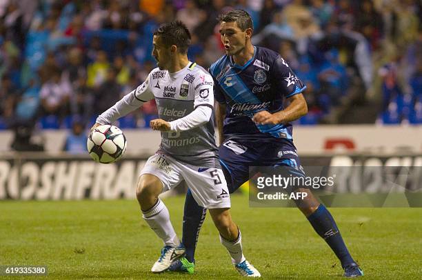 Alvaro Navarro of Puebla vies for the ball with Fernando Navarro of Leon, during their Mexican Apertura 2016 Tournament football match, at the...
