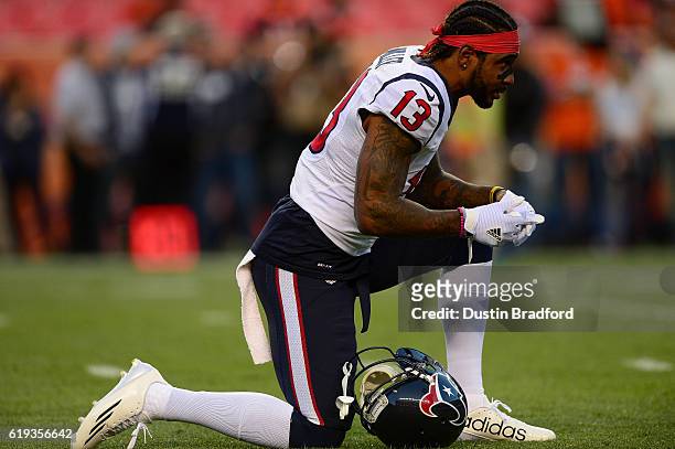 Wide receiver Braxton Miller of the Houston Texans stretches as he warms up before a game against the Denver Broncos at Sports Authority Field at...