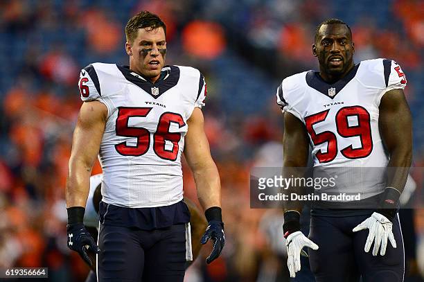 Inside linebacker Brian Cushing and outside linebacker Whitney Mercilus of the Houston Texans stand on the field before a game against the Denver...