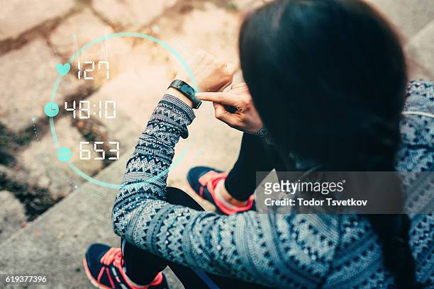 runner using smart watch - checking sports stock pictures, royalty-free photos & images