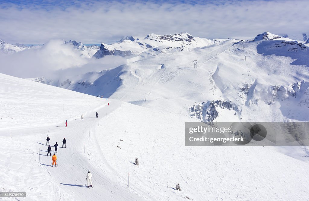 People skiing in the Grand Massif ski area in France