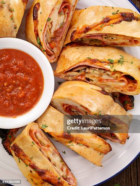 stromboli with pepperoni, salami, mushrooms and peppers - calzone stock pictures, royalty-free photos & images